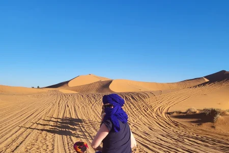 Camel caravan crossing the dunes on the shared 2-day tour from Marrakech to Zagora